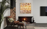 an abstract painting hangs above a fireplace in a living room