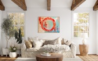 a living room with white walls and wooden beams