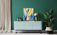 an abstract painting in a living room with green walls