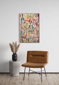 an abstract painting hanging on a wall next to a chair