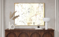 an abstract painting hangs above a dresser in a living room