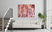 an abstract painting hangs above a couch in a living room